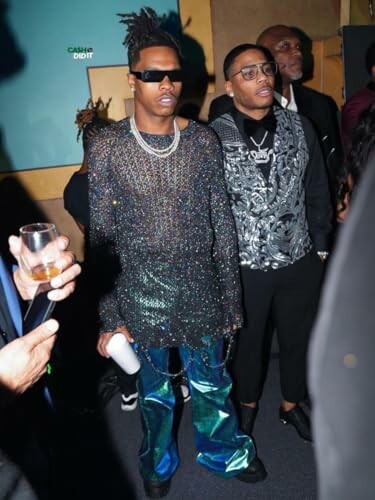 Two men in fashionable outfits at a party